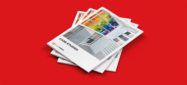 Mobile image of a stack of brochures taken from a marketing Customer Attraction case study, with a red colour background.