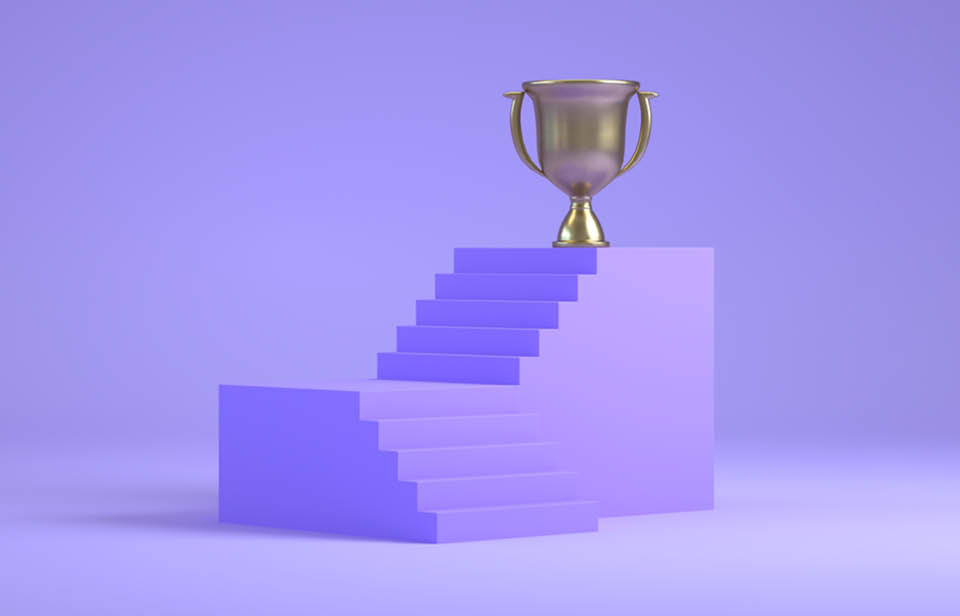 A set of steps with a gold trophy on top